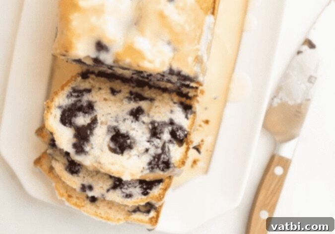 27 Deliciously Easy Blueberry Desserts 15 A loaf of blueberry bread on a white plate.