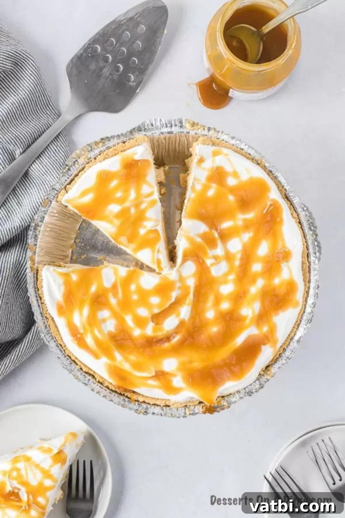 Irresistible Salted Caramel Pie 2 No bake salted caramel pie being sliced, revealing its creamy layers and golden caramel topping.