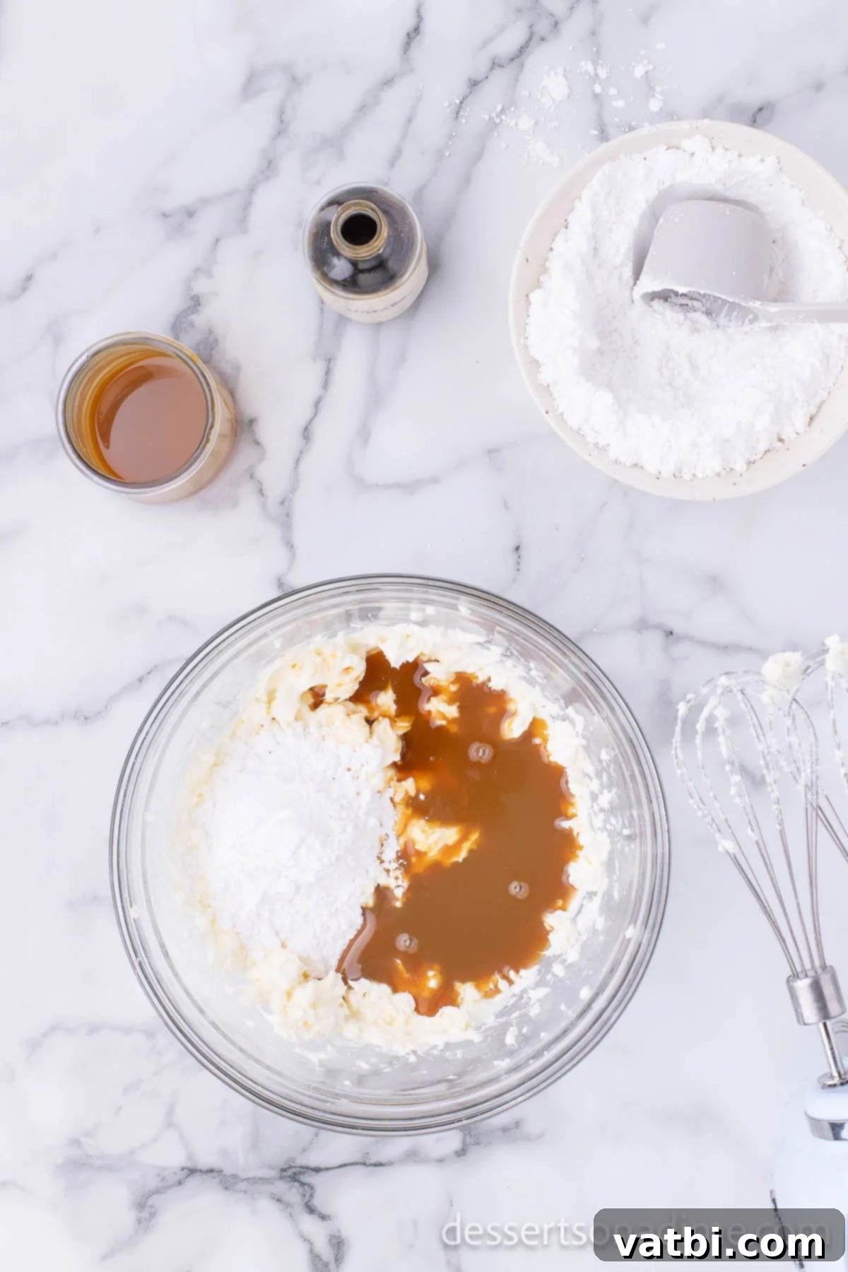 Irresistible Salted Caramel Pie 5 Salted caramel sauce and vanilla extract added to the cream cheese mixture in a bowl.