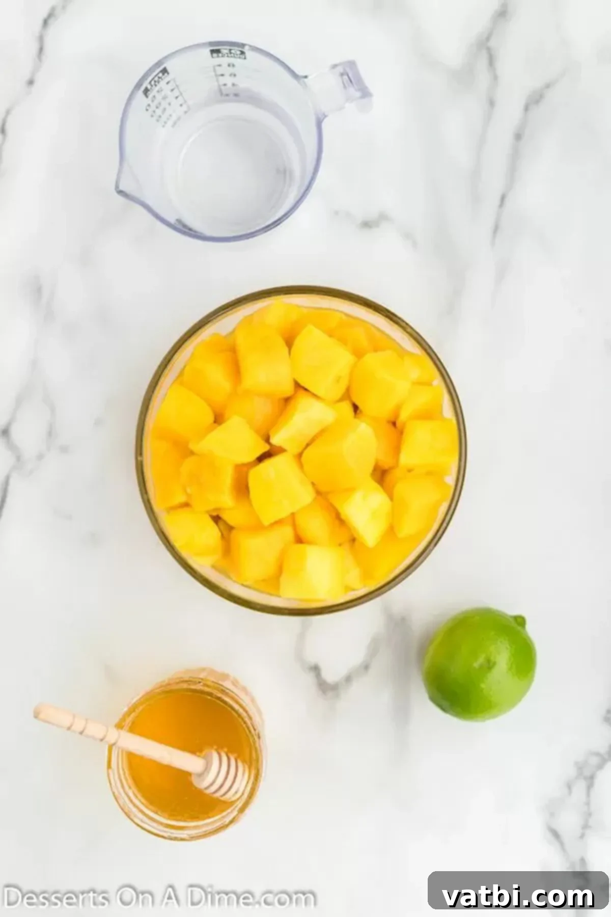 Sunshine Mango Freezies 3 Four key ingredients for mango popsicles: fresh diced mango, golden honey, a vibrant lime, and clear water.