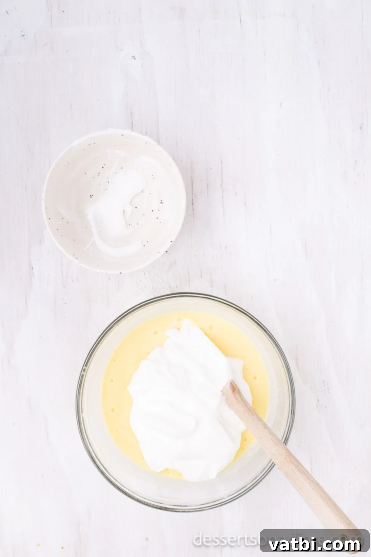 Divine Decadence Cake 6 Mixing bowl with instant pudding mix, milk, and sour cream combined.