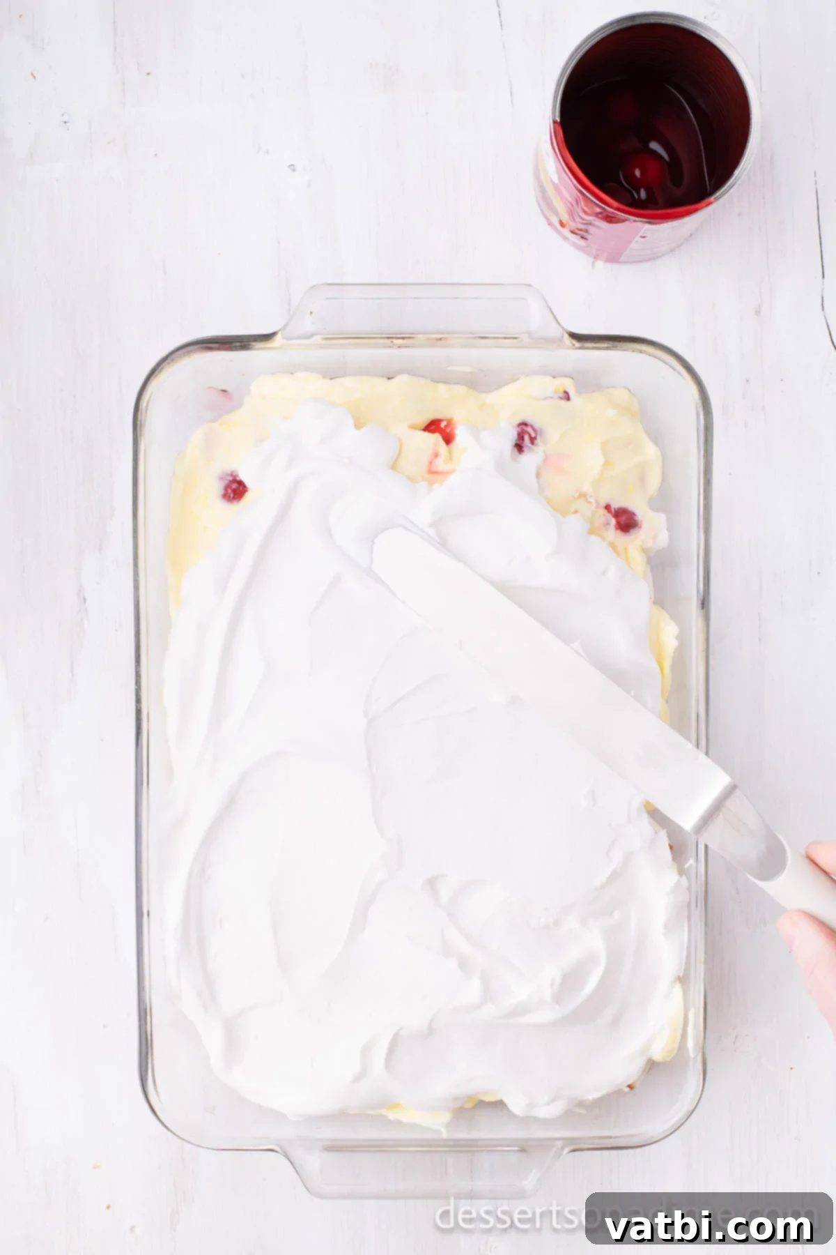 Divine Decadence Cake 8 Cake topped with whipped cream, spread smoothly.