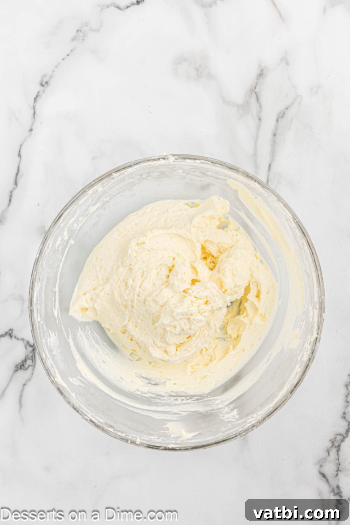 A bowl filled with freshly made, fluffy keto cream cheese frosting, ready to be used on the carrot cake.