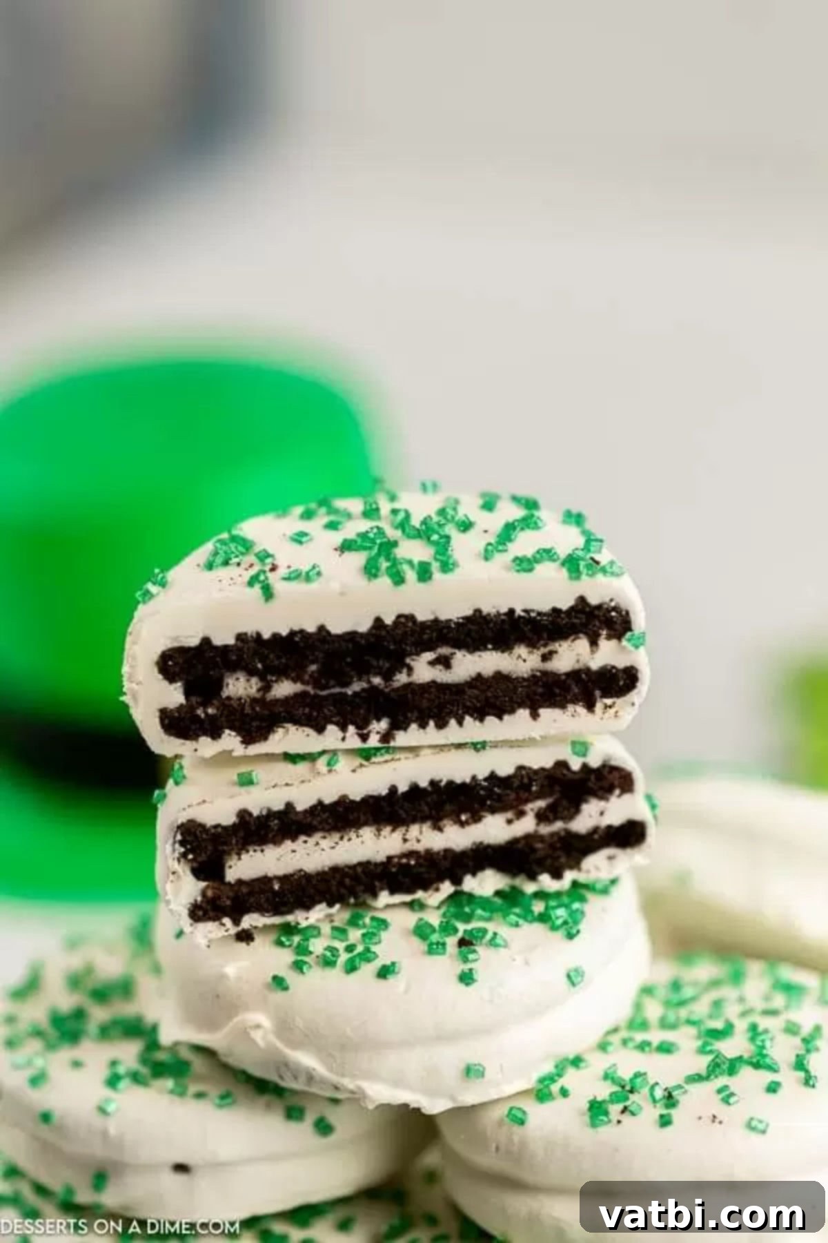 St Patricks Day Oreo Chocolate Delights 6 St Patrick's Day Chocolate covered oreos stacked and cut in half, showcasing the Oreo inside.