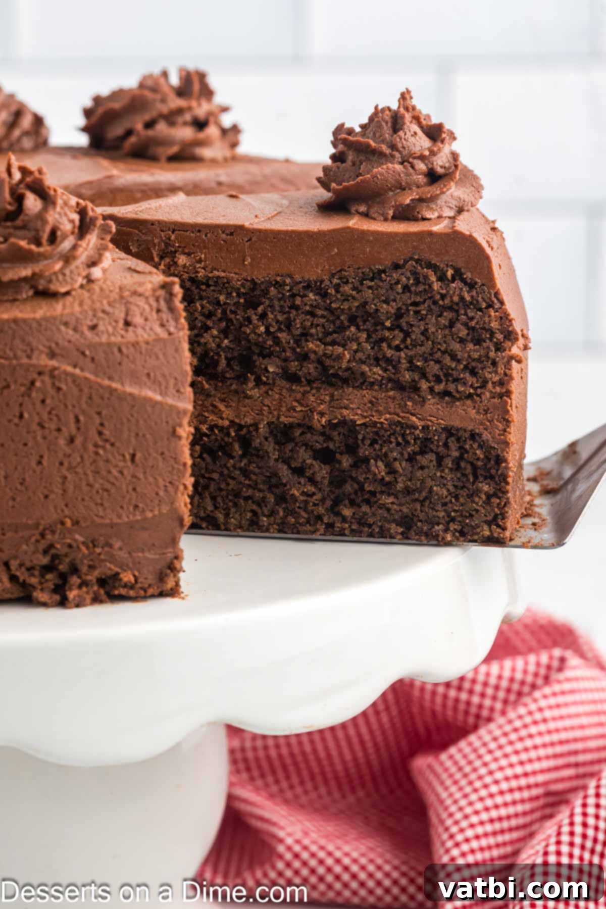 Decadent Keto Chocolate Delight 2 A perfectly sliced piece of rich Keto Chocolate Cake with a smooth, glossy frosting, artfully presented on a white plate, inviting indulgence.