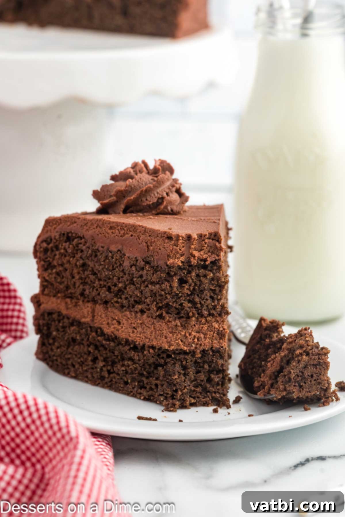 Decadent Keto Chocolate Delight 4 A beautifully presented slice of Keto Chocolate Cake, layered with rich frosting and garnished, inviting a taste.