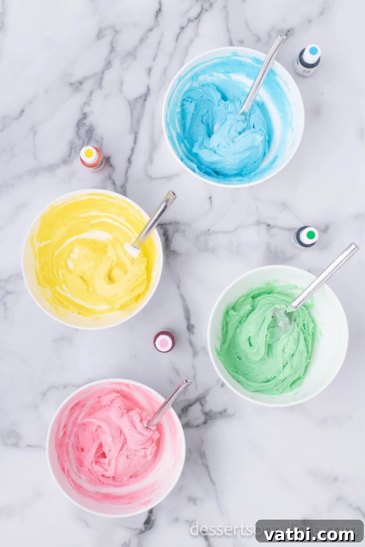 Dough divided between bowls with food coloring. 
