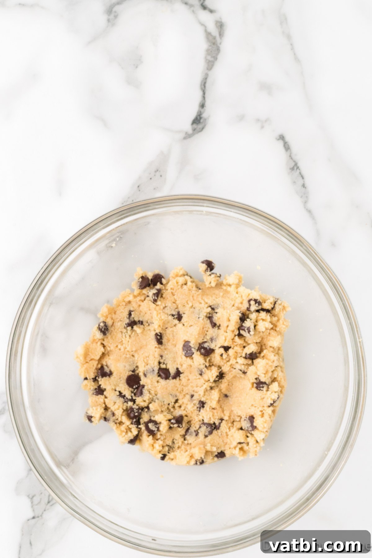 Guilt-Free Keto Chocolate Chip Delights 4 Mixing dry ingredients in a bowl for keto chocolate chip cookies.