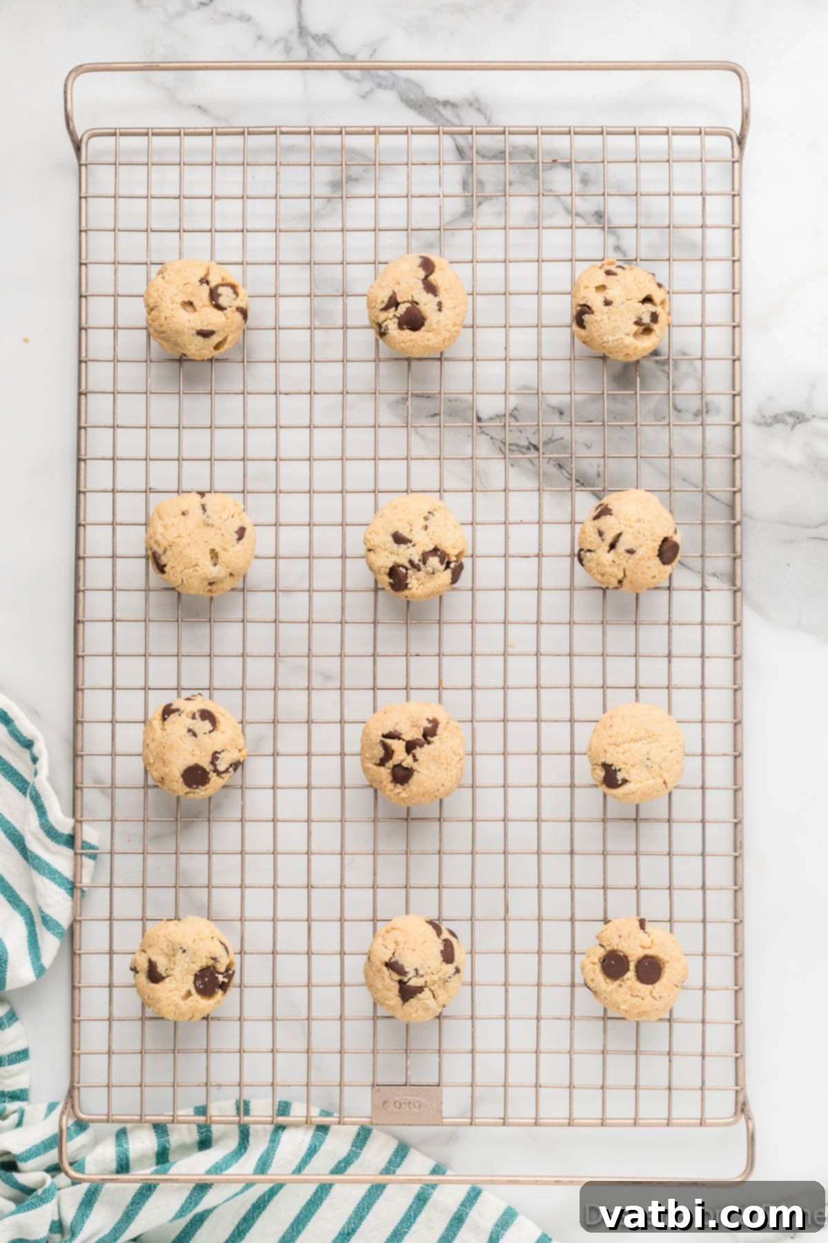Guilt-Free Keto Chocolate Chip Delights 6 Keto chocolate chip cookies cooling on a baking sheet.