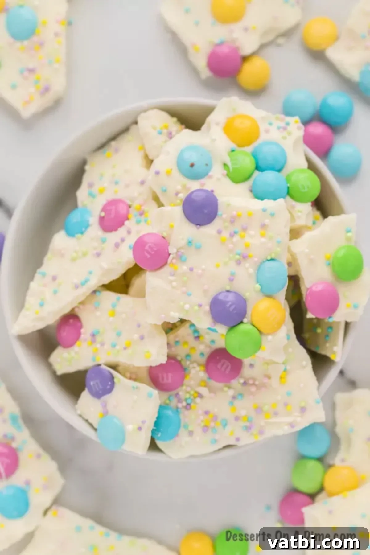 Delightful White Chocolate Easter Bark 8 Close up image of Easter White Chocolate Bark with spring color candy and sprinkles.