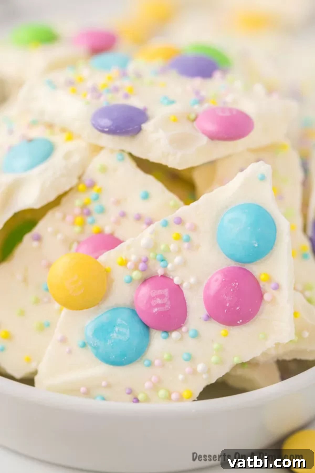 Delightful White Chocolate Easter Bark 9 Close up image of Easter White Chocolate Bark with spring color candy and sprinkles.