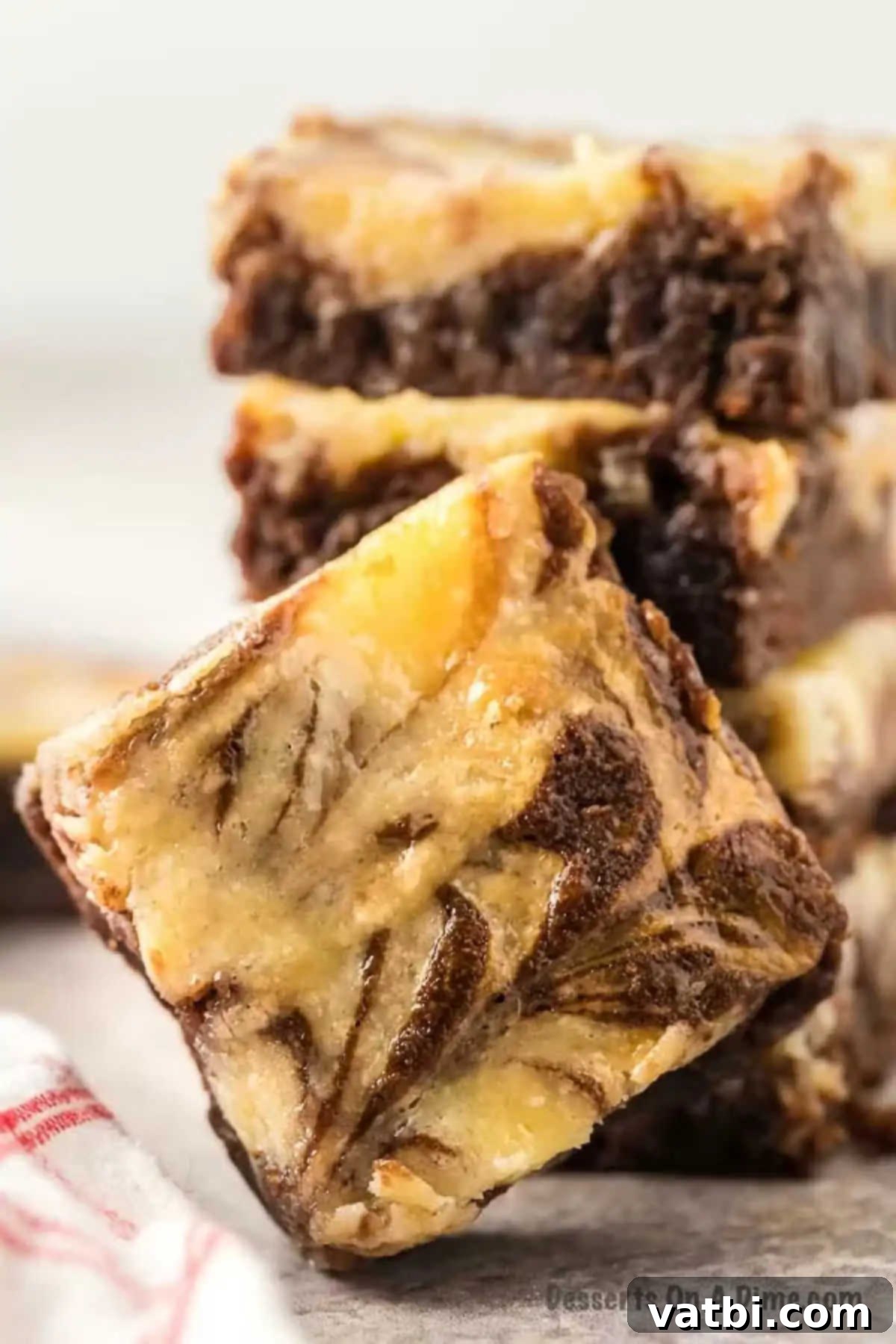Decadent Cream Cheese Swirl Brownies 2 Cream cheese brownies cut into squares.