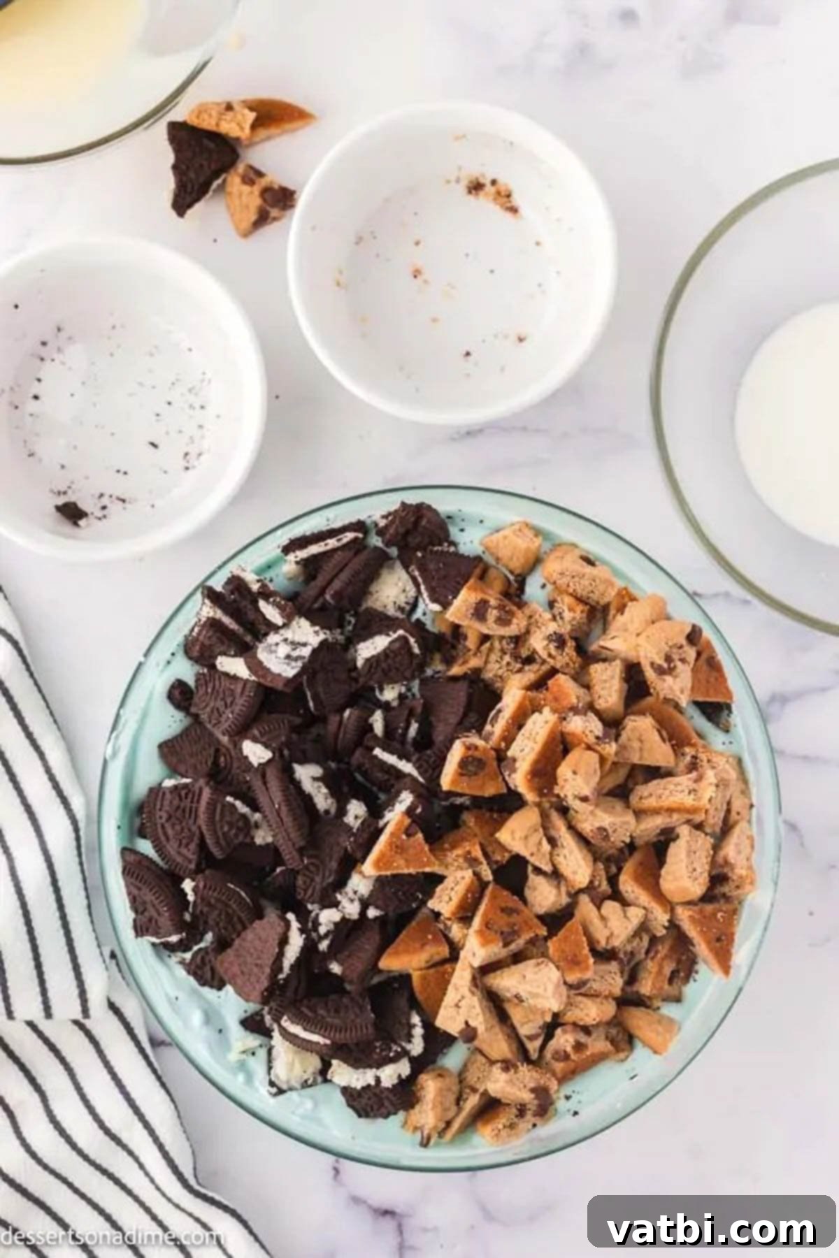 The blue ice cream base with chunky cookie pieces folded in, showing a rich, creamy texture.
