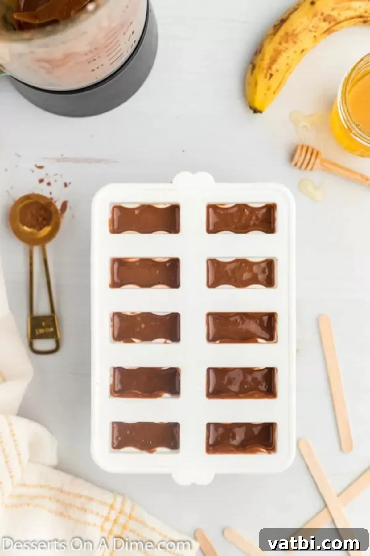Ultimate Chocolate Banana Pops 6 Popsicle molds filled with the chocolate banana mixture, ready for freezing.