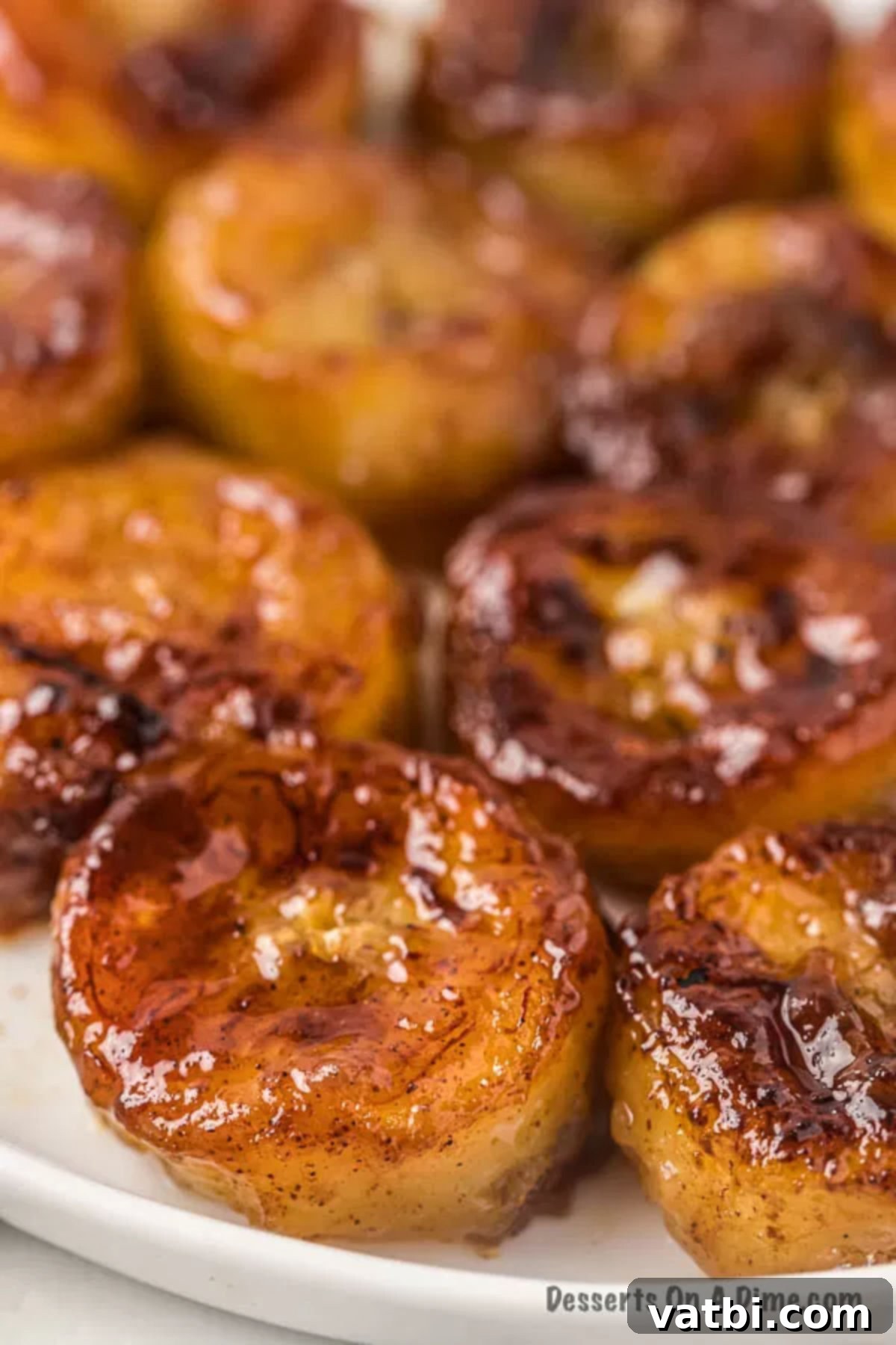 Sweet Golden Banana Bites 2 Close up photo of golden brown fried bananas, perfectly caramelized, served on a white plate.