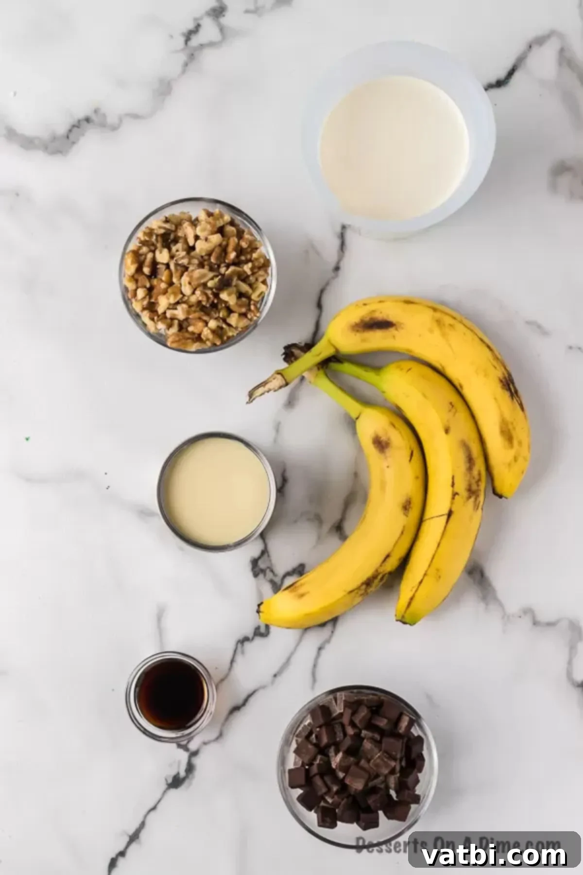 Primate's Perfect Scoop 3 A flat lay of ingredients for chunky monkey ice cream: heavy whipping cream, sweetened condensed milk, vanilla extract, and ripe bananas.