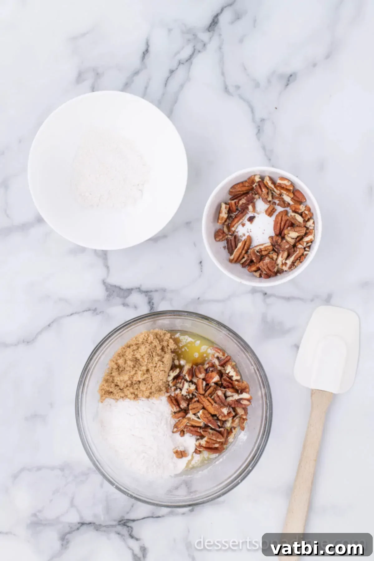 Mixing bowl with flour, brown sugar, pecans and melted butter. 
