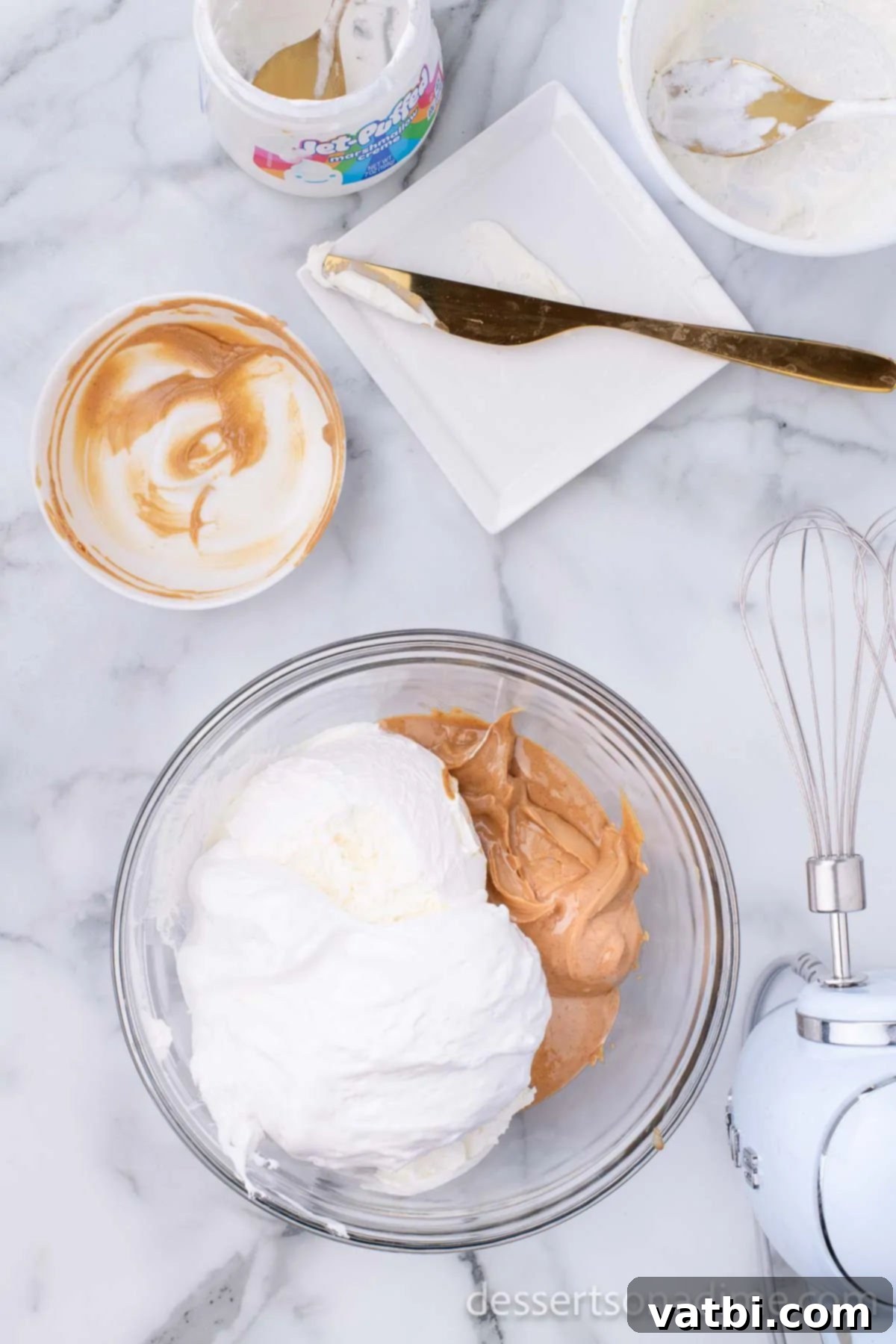Whipped Peanut Butter Delight 5 Mixing bowl with cream cheese, peanut butter, marshmallow creme, and cool whip being blended.