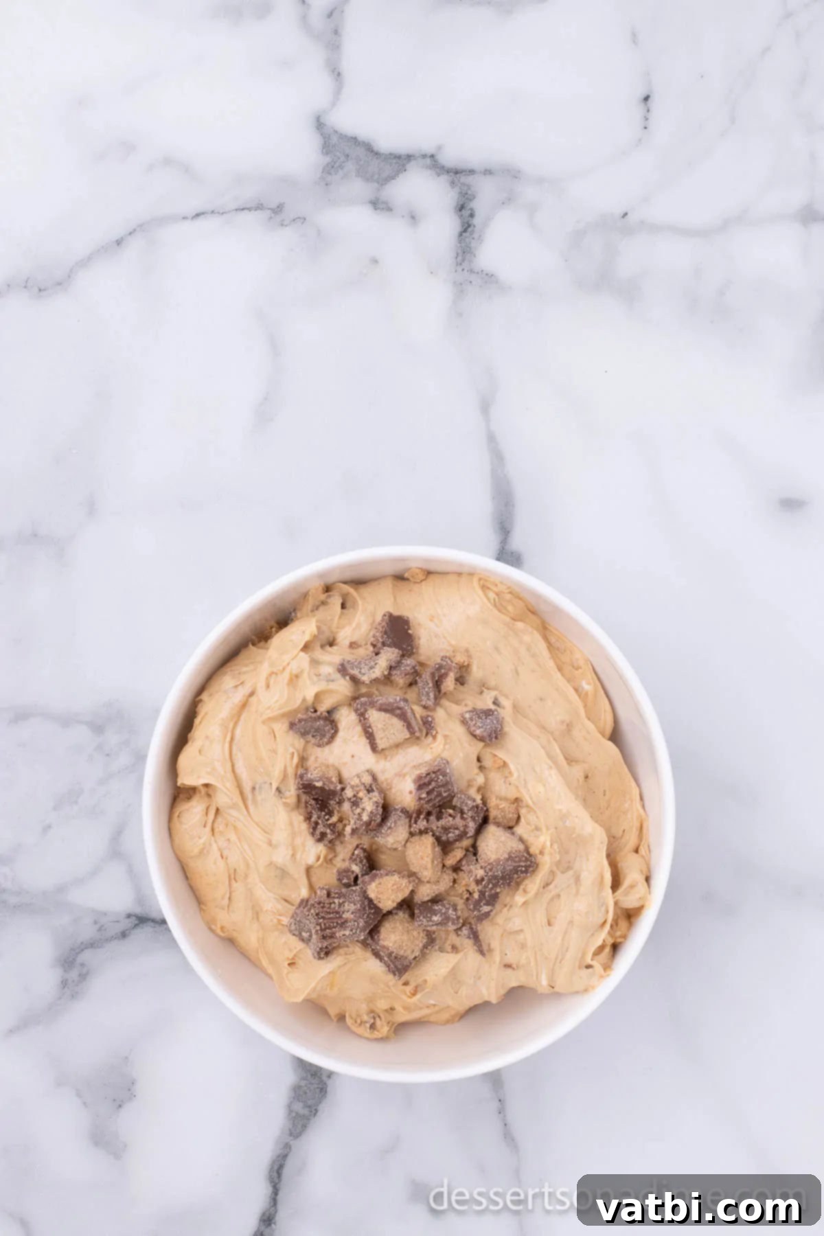 Whipped Peanut Butter Delight 7 A finished bowl of peanut butter fluff, topped with reserved candy pieces and ready to be served.