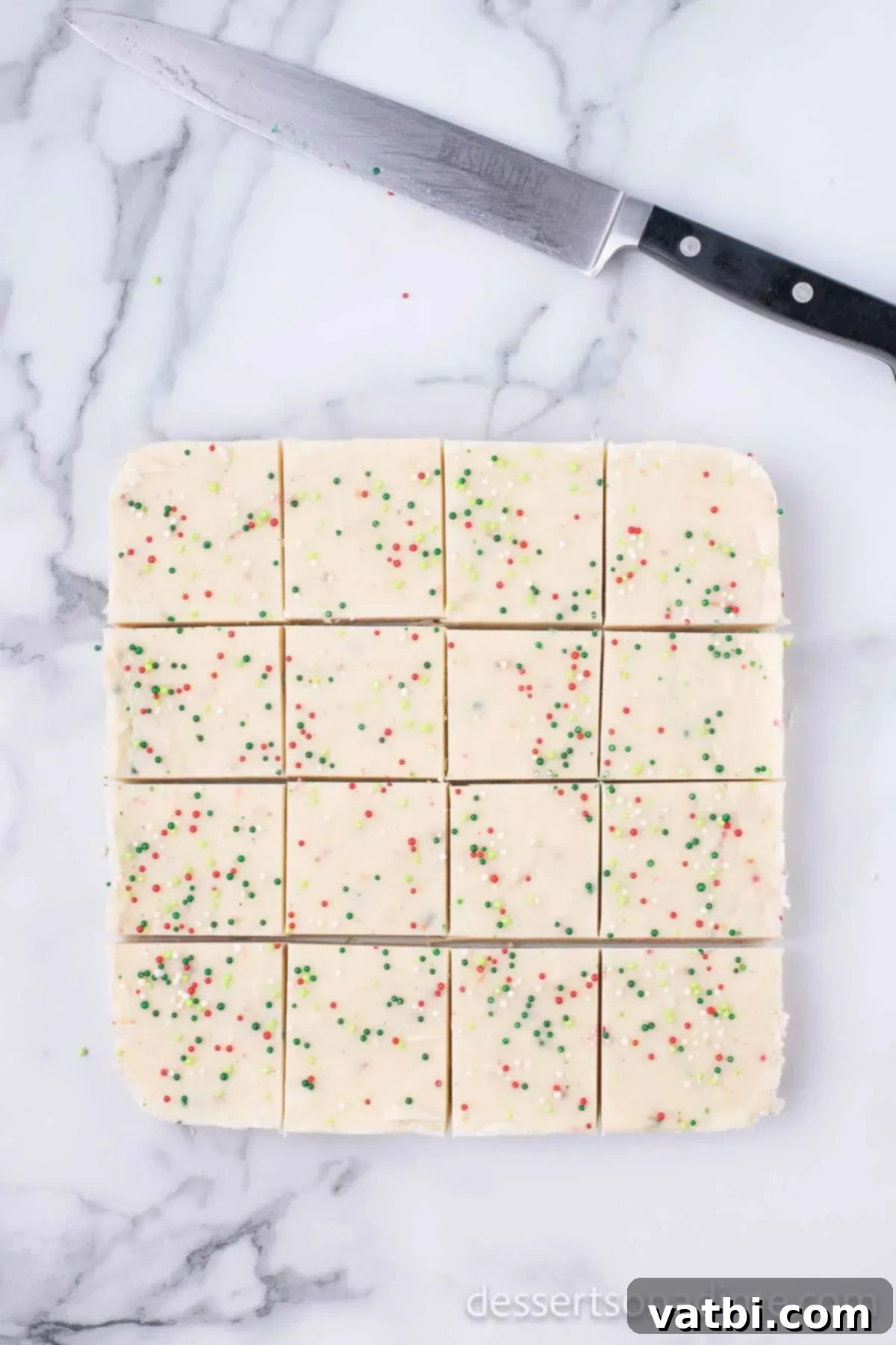 Ultimate Sugar Cookie Fudge 9 Set sugar cookie fudge, perfectly cut into small, square pieces, ready to be served.