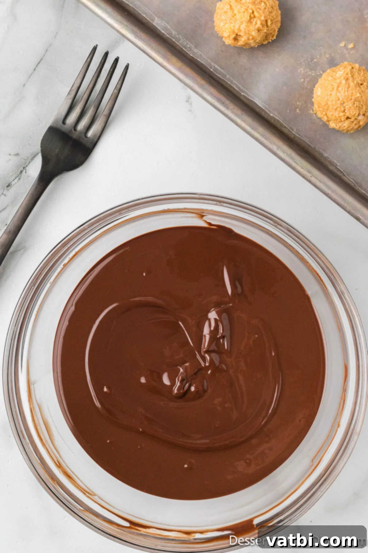 Peanut Butter Crisp Bites 11 Chocolate melted in bowl.
