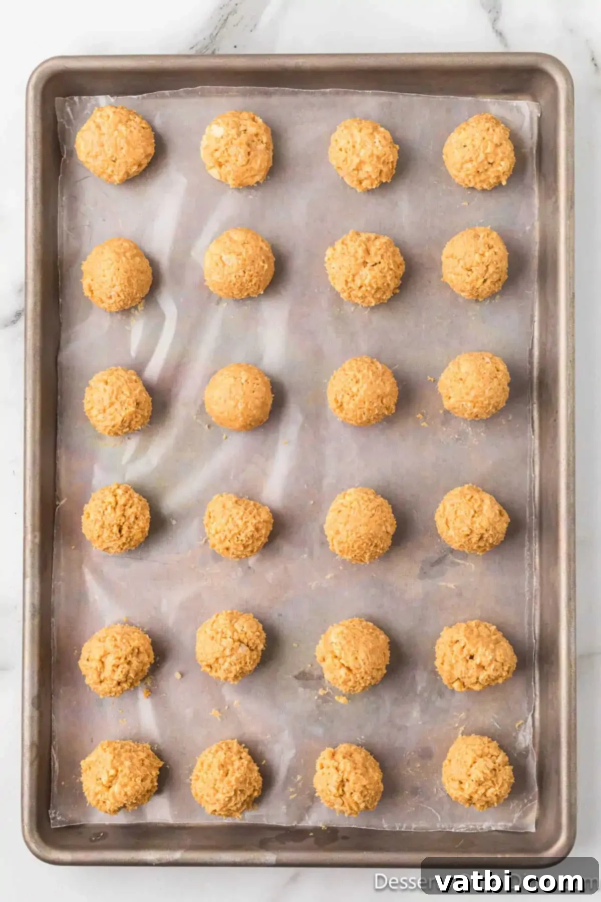 Peanut Butter Crisp Bites 9 Dough formed into balls and placed on baking sheet.
