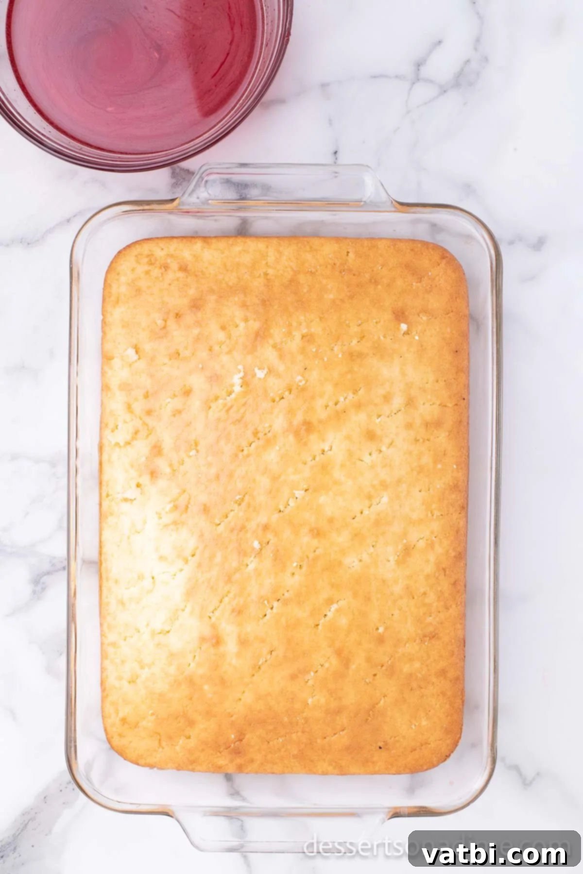 Holes strategically poked all over the cooled cake surface.