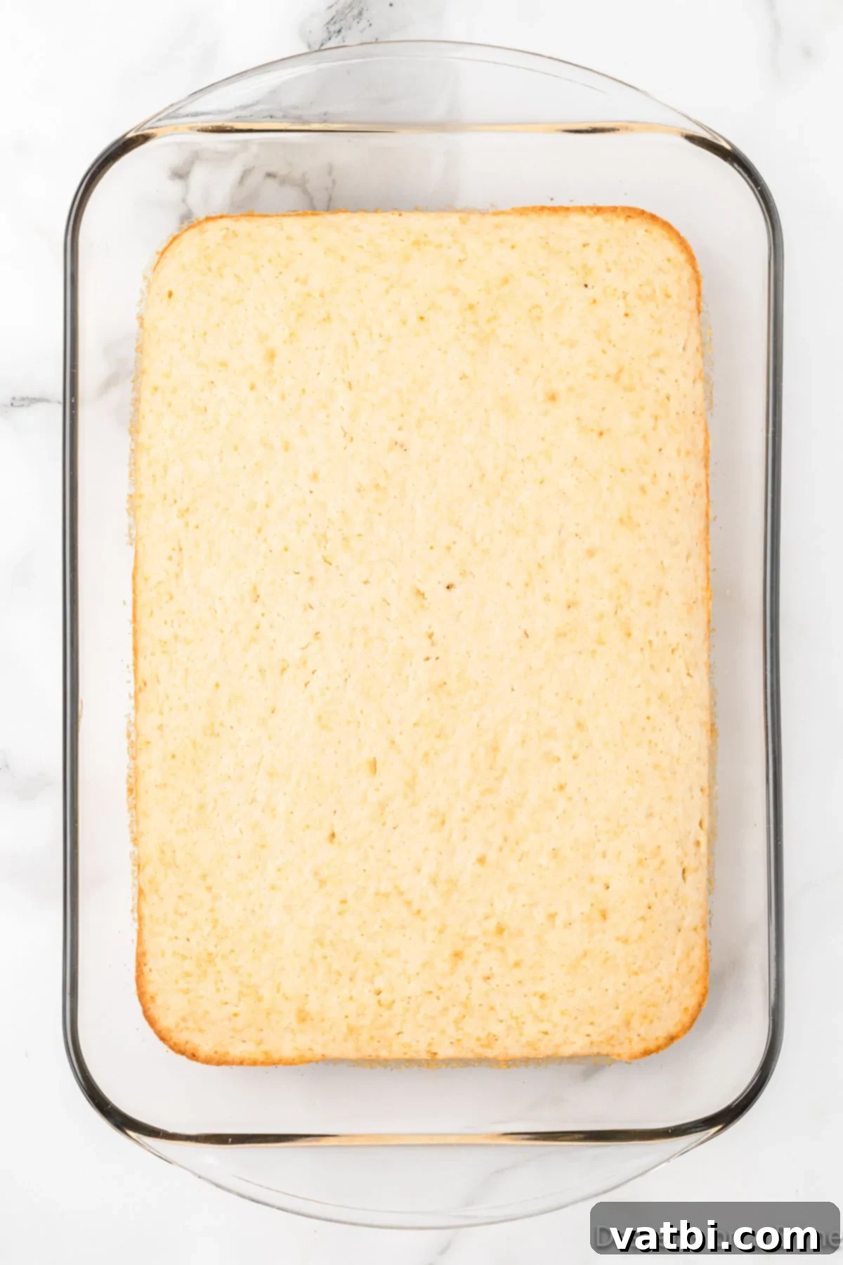 Homemade Vanilla Cake Delights 3 Freshly baked cake cooling in a 9x13 inch pan.