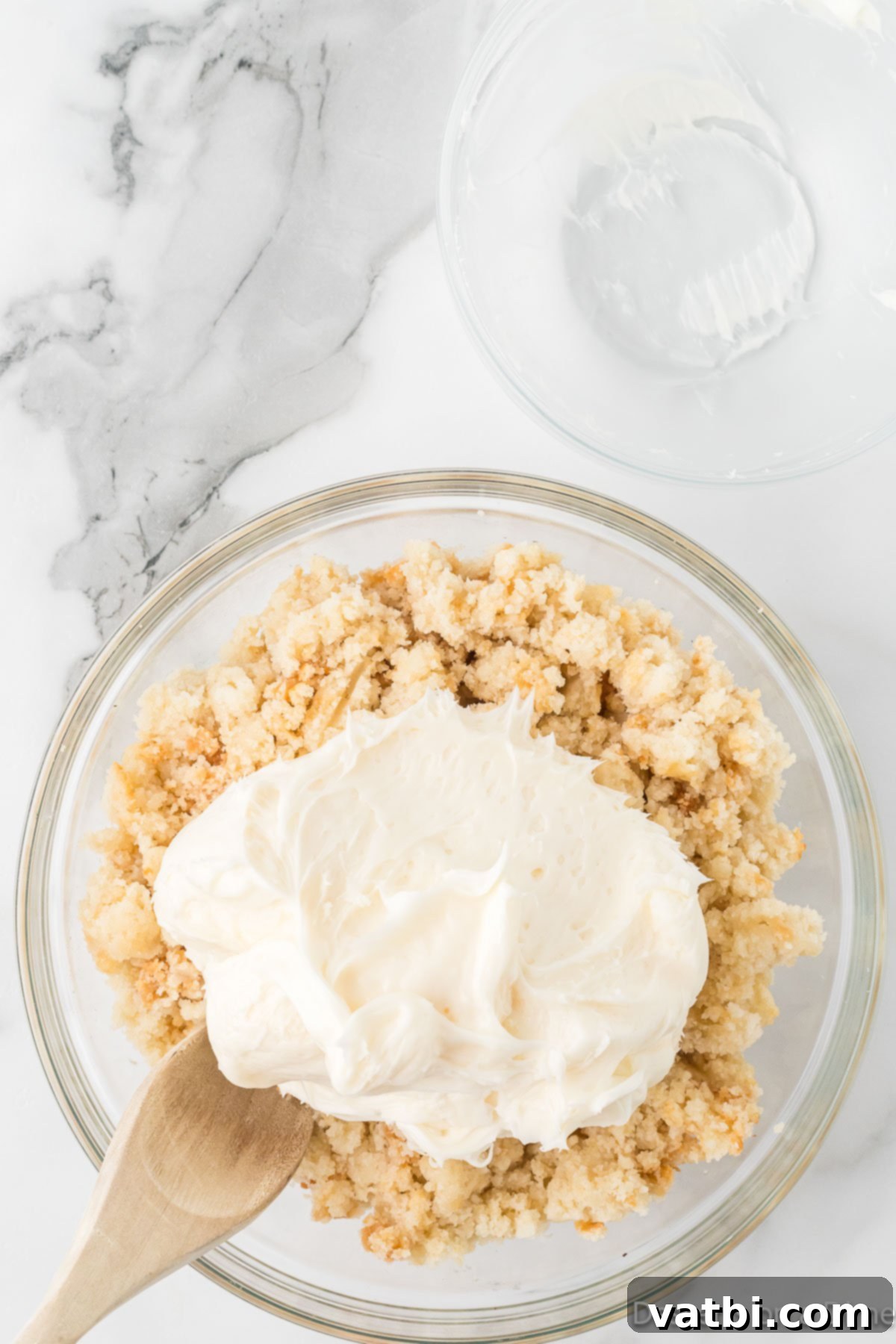 Homemade Vanilla Cake Delights 4 Crumbled vanilla cake in a large mixing bowl with vanilla frosting.