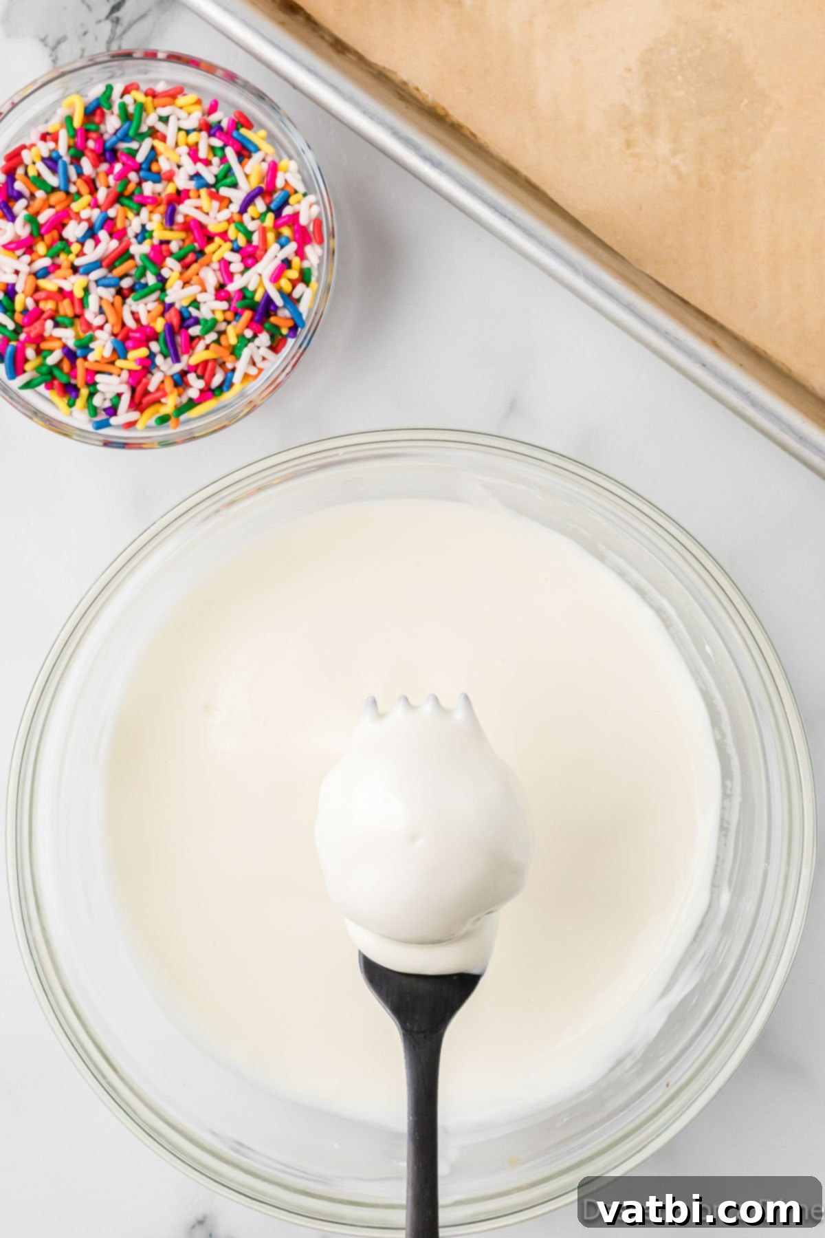 Homemade Vanilla Cake Delights 7 Frozen cake balls being dipped into smooth melted chocolate or almond bark.