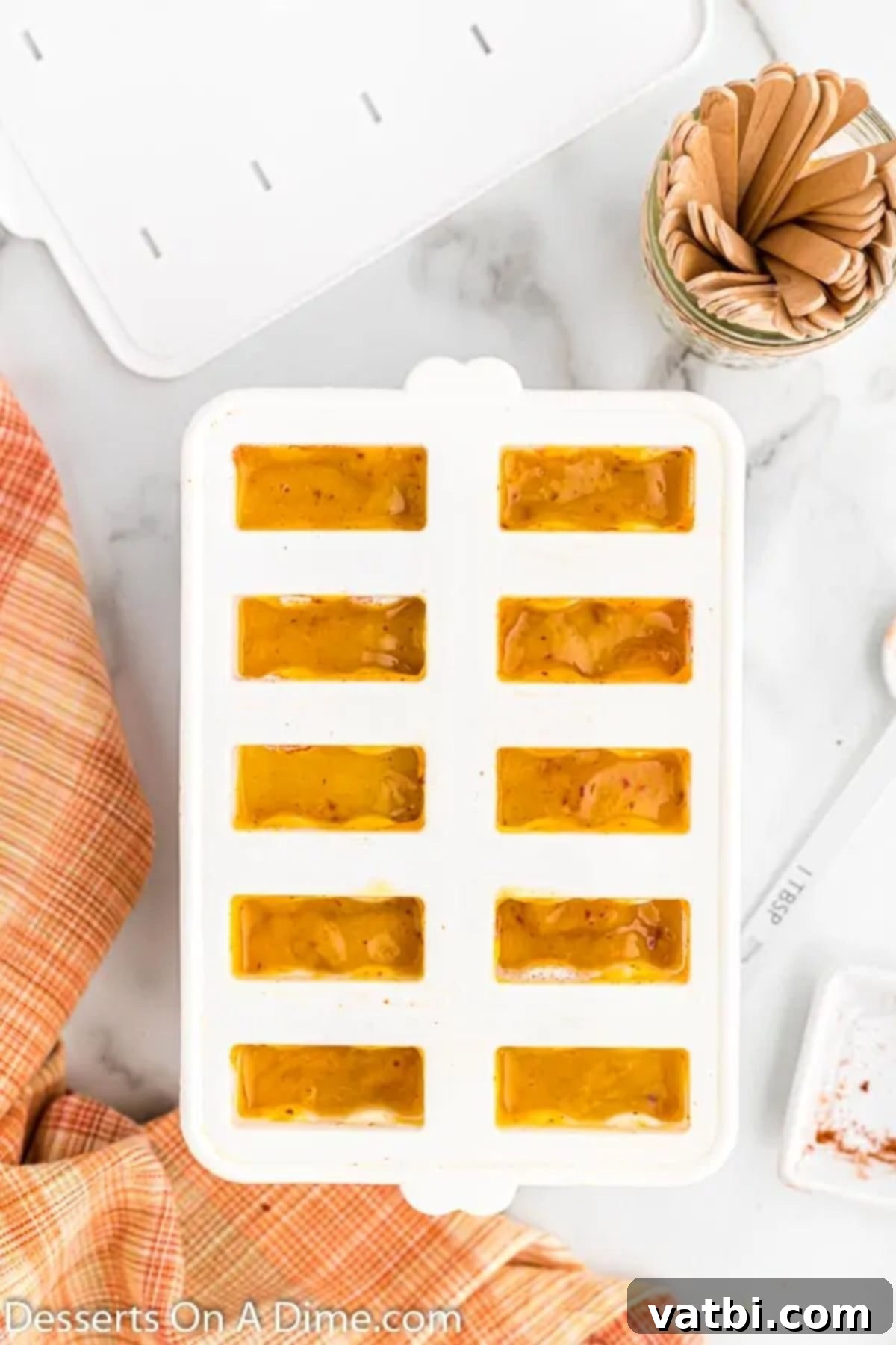 Zesty Mango Tajin Popsicles 8 The blended mango mixture is carefully poured into the prepared popsicle molds.