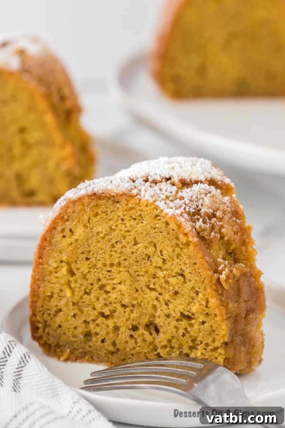Deliciously Addictive Cake 2 A perfectly sliced piece of moist Crack Cake, revealing its rich texture and delicious wine glaze glistening on top.