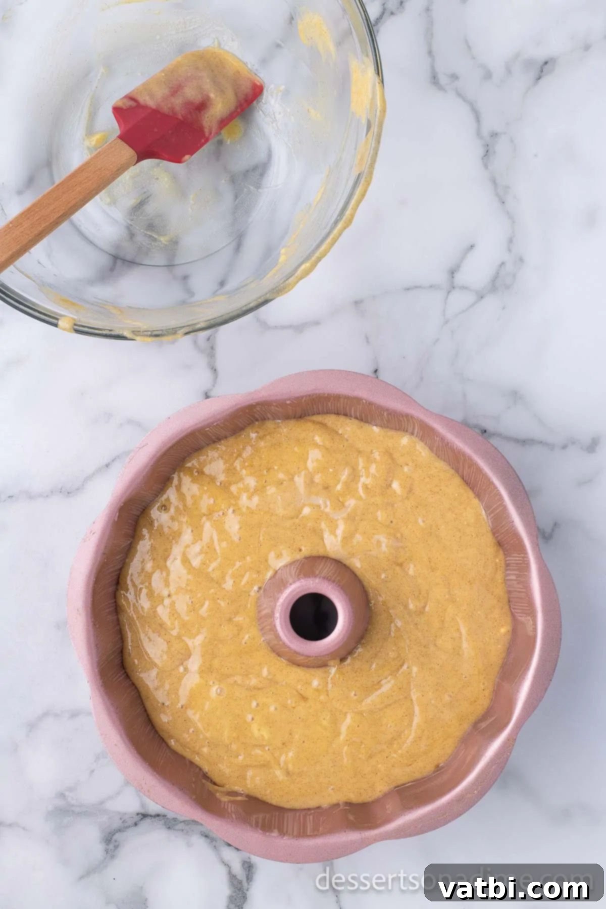 Deliciously Addictive Cake 5 Pouring the smooth, golden cake batter evenly into the well-greased bundt pan before baking.