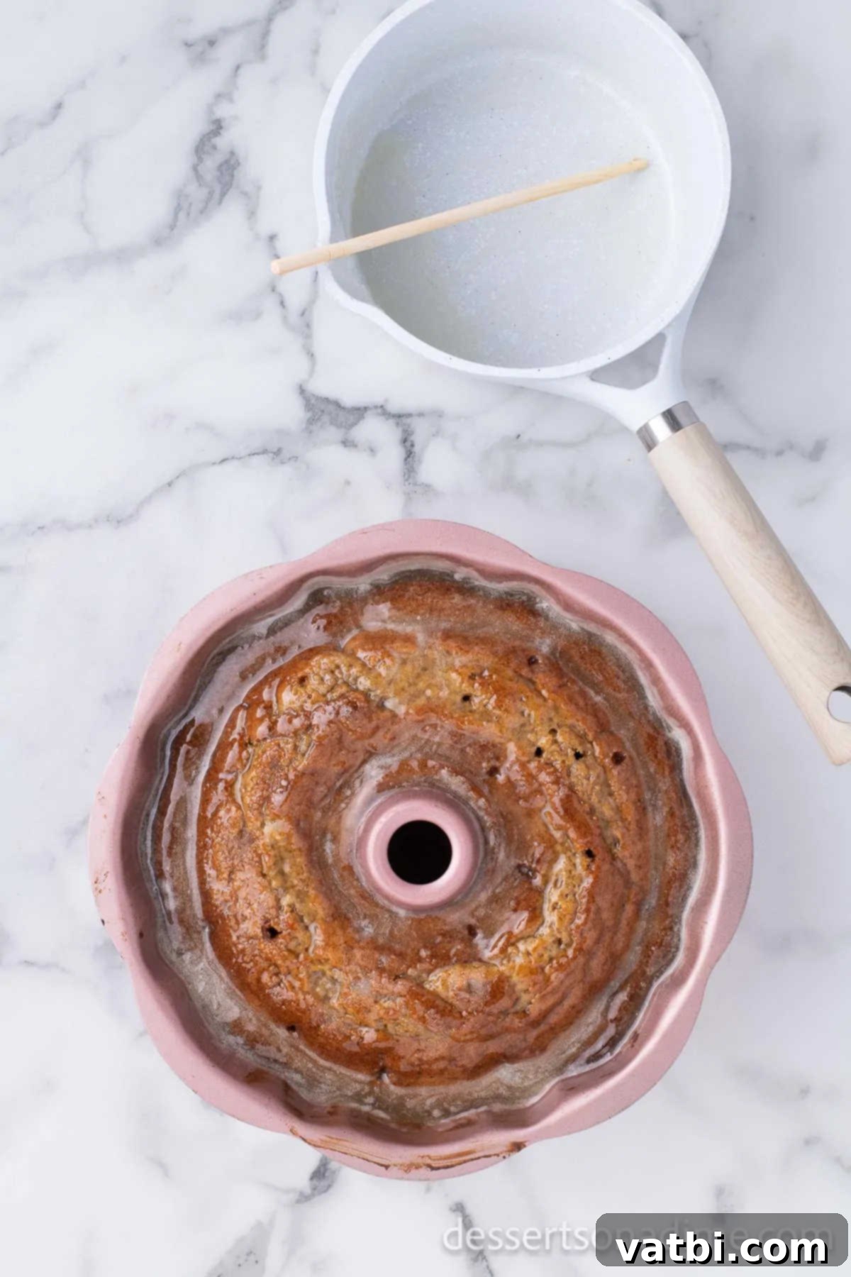 Deliciously Addictive Cake 7 Generously pouring the warm white wine glaze over the freshly baked, hole-poked Bundt cake still in its pan, allowing it to soak in.