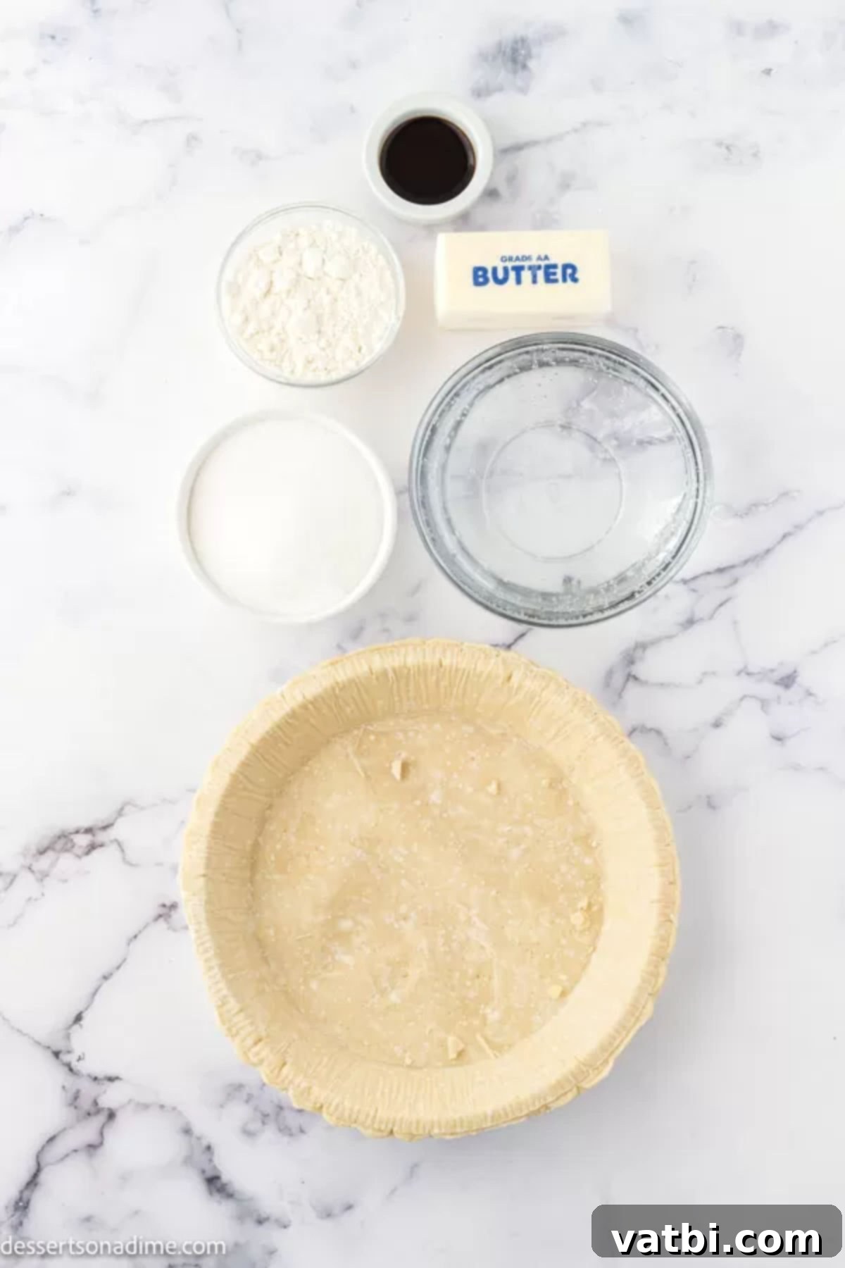 Bubbly Lemon-Lime Pie 3 Ingredients for Sprite pie - Sugar, flour, butter, frozen pie crust, sprite, vanilla extract arranged neatly.