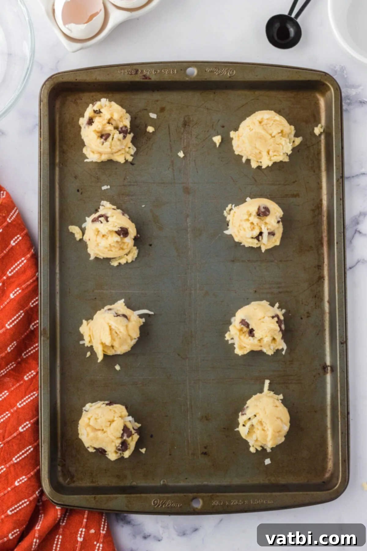 Island Chocolate Chip Bliss 8 Cookie Dough balls on cookie sheet.