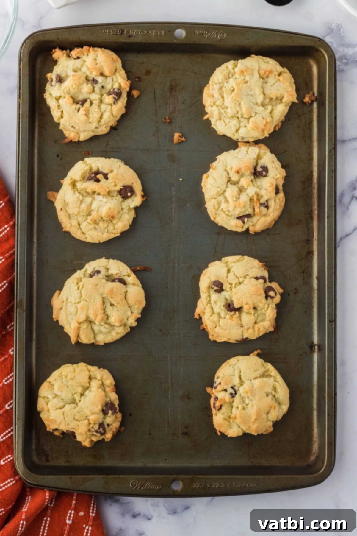 Island Chocolate Chip Bliss 9 Cookies baked and cooling on baking sheet.
