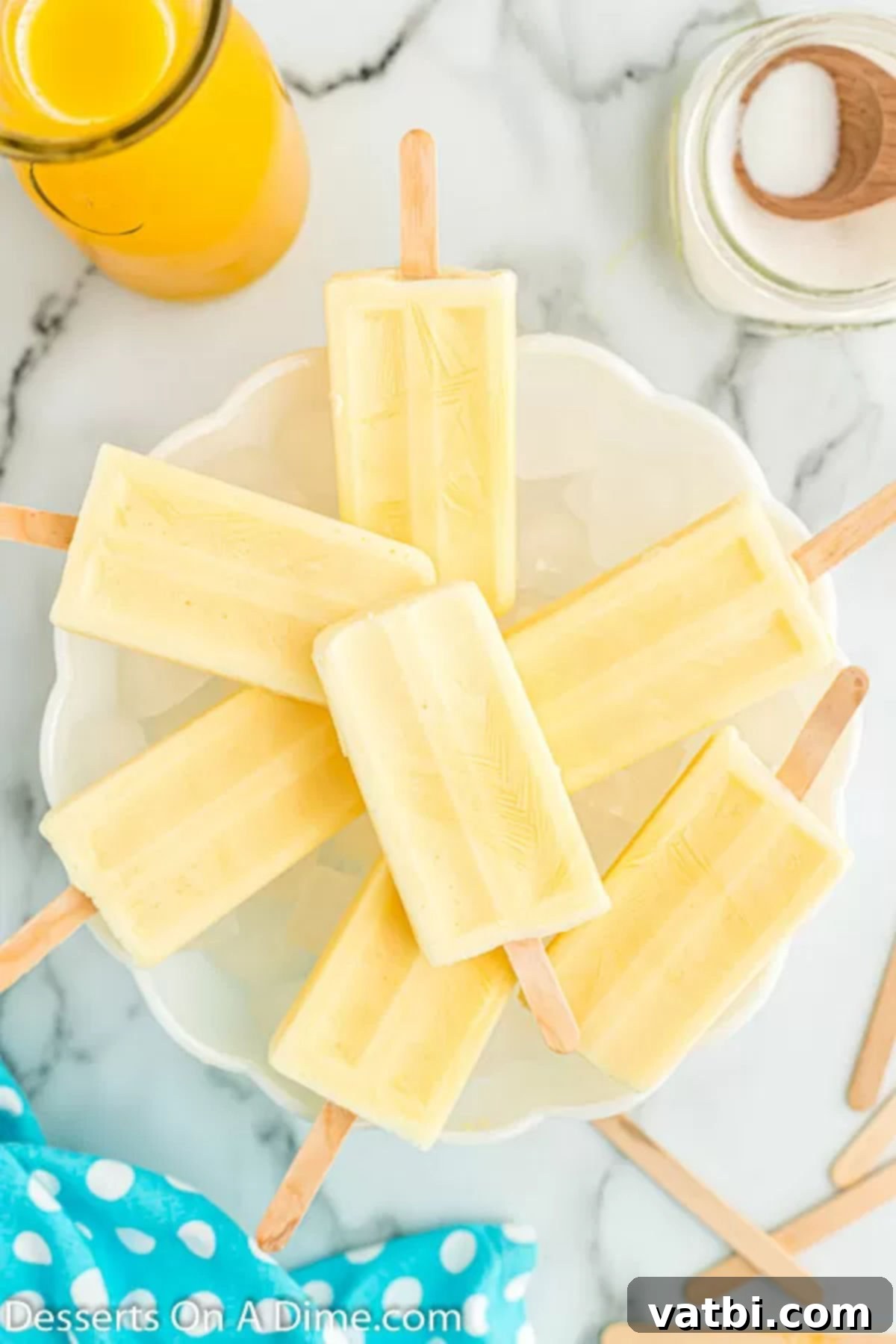 Orange Swirl Dream Pop 2 Orange creamsicle popsicles on a platter.