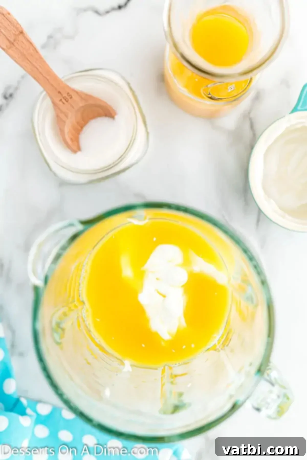 Orange Swirl Dream Pop 4 Measuring cup with ingredients mixed together.