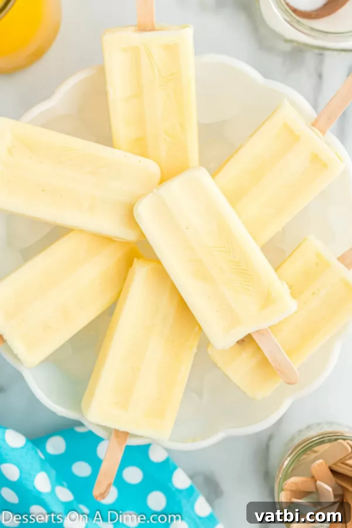 Orange Swirl Dream Pop 8 Orange creamsicle popsicles on a platter.