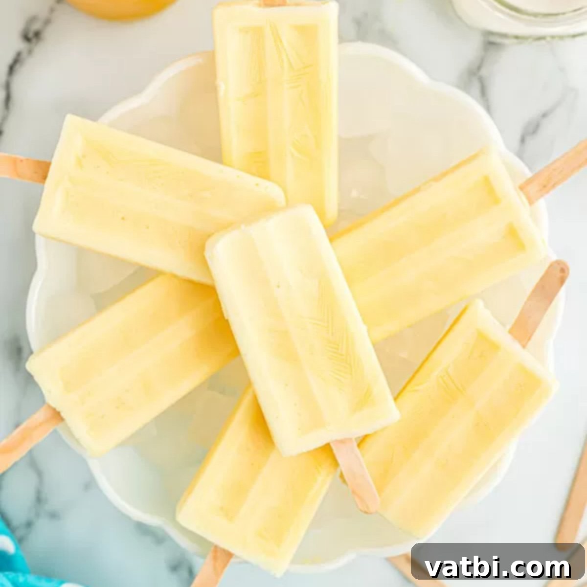 Orange Swirl Dream Pop 9 Popsicles on a plate.