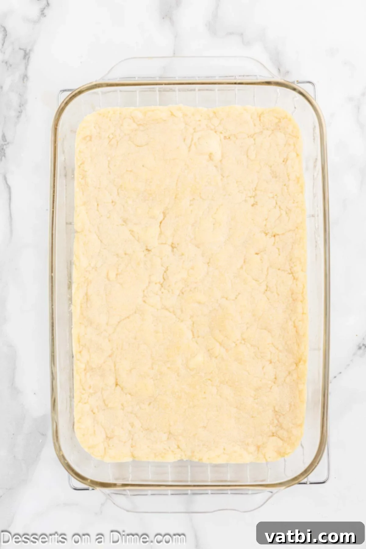 Homemade Sugar Cookie Squares 7 Baked sugar cookie bars cooling in the pan on a wire rack.