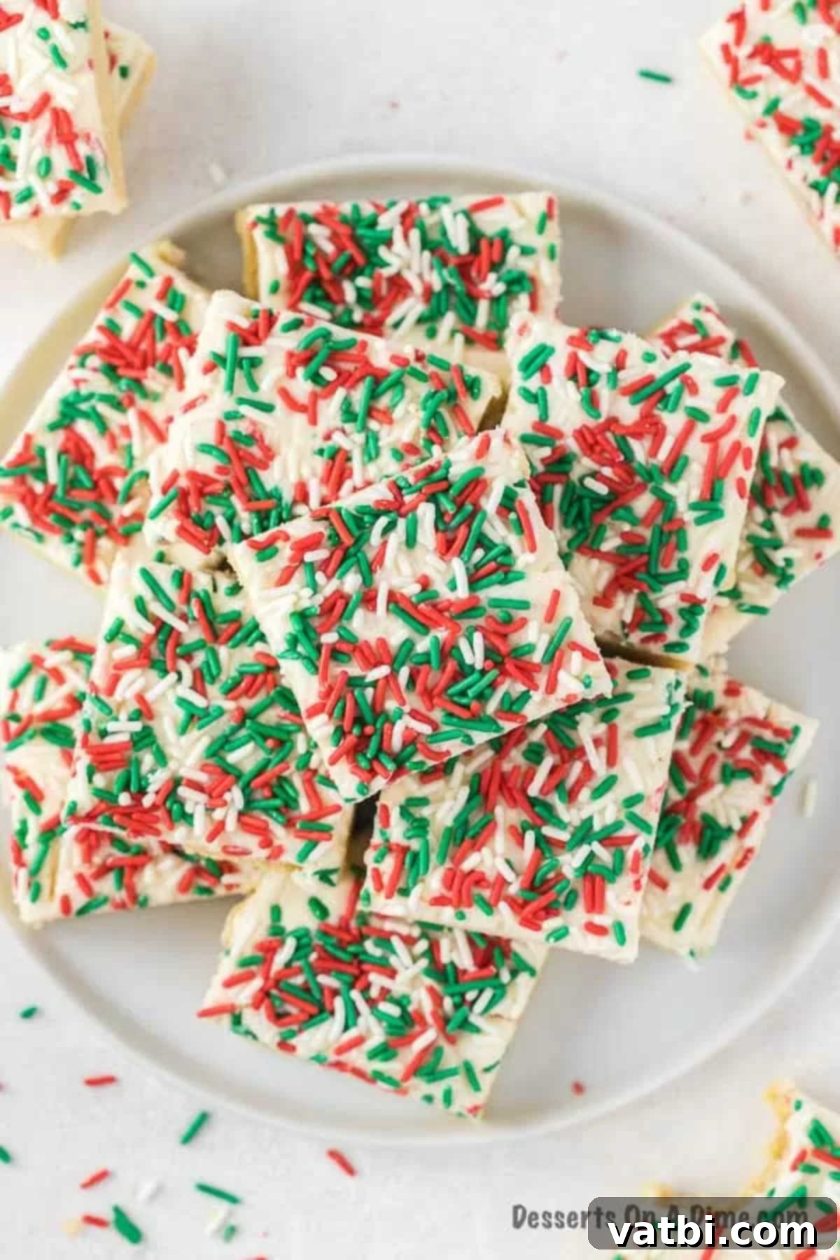 Frosted Christmas Sugar Cookie Bars 2 Christmas sugar cookie bars on a plate.