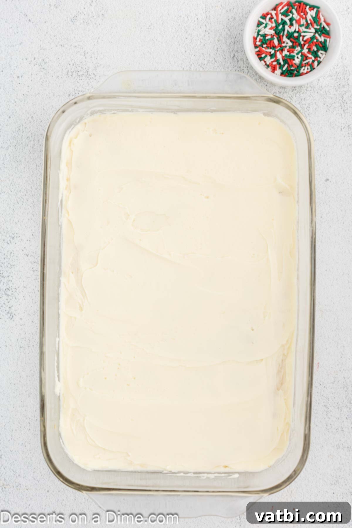 Frosted Christmas Sugar Cookie Bars 8 Frosting spread over the crust.