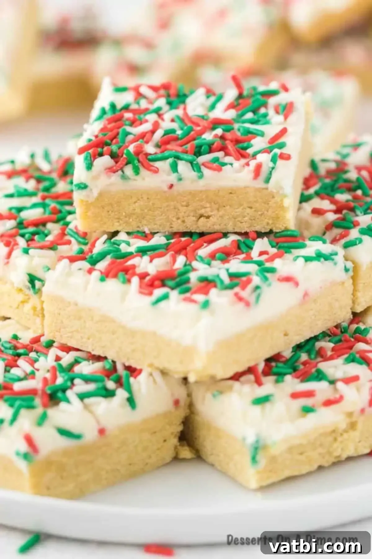 Frosted Christmas Sugar Cookie Bars 10 Christmas sugar cookie bars on a plate.