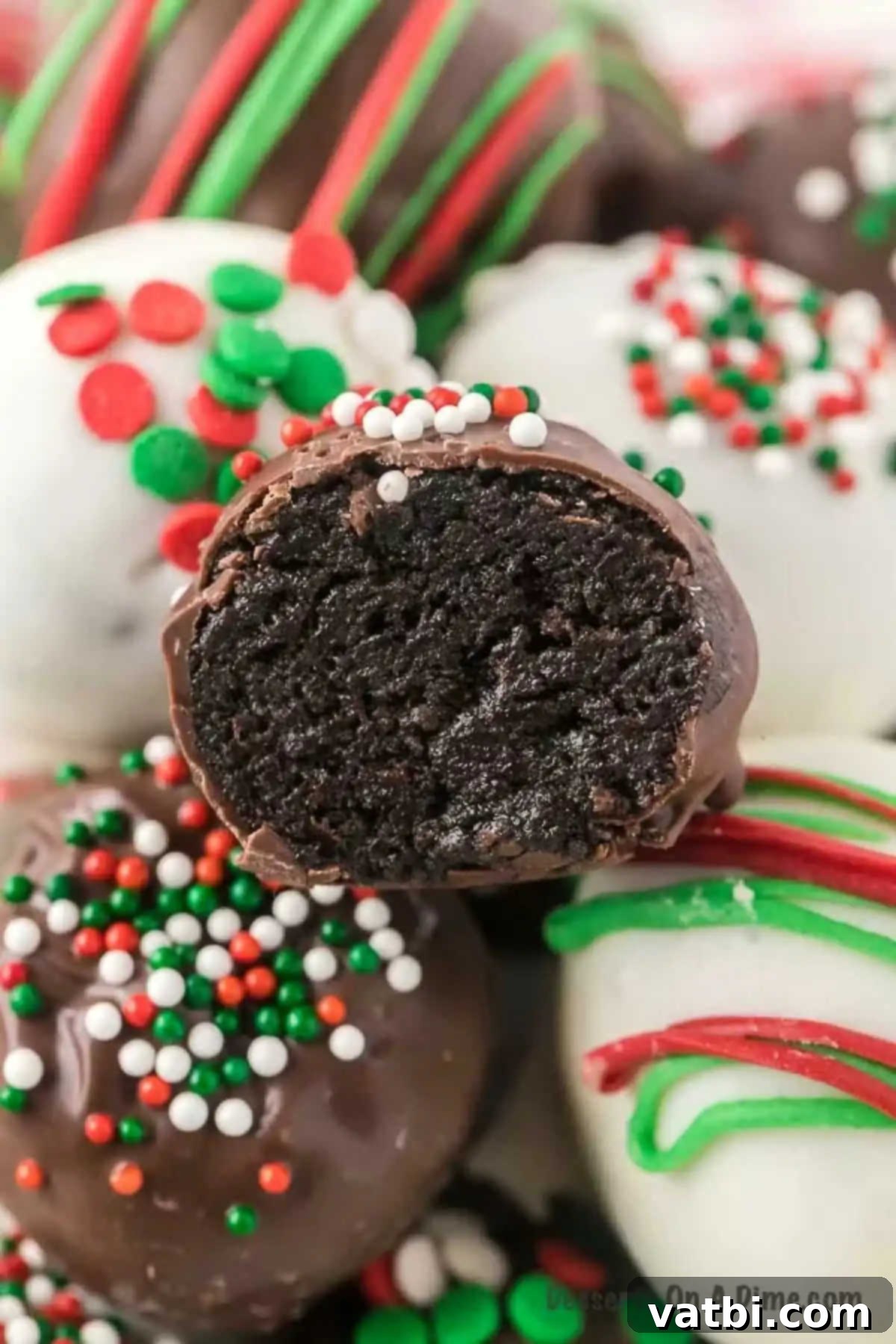Easy Christmas Oreo Balls 2 Close up photo of an Oreo ball cut in half, revealing the creamy Oreo filling.