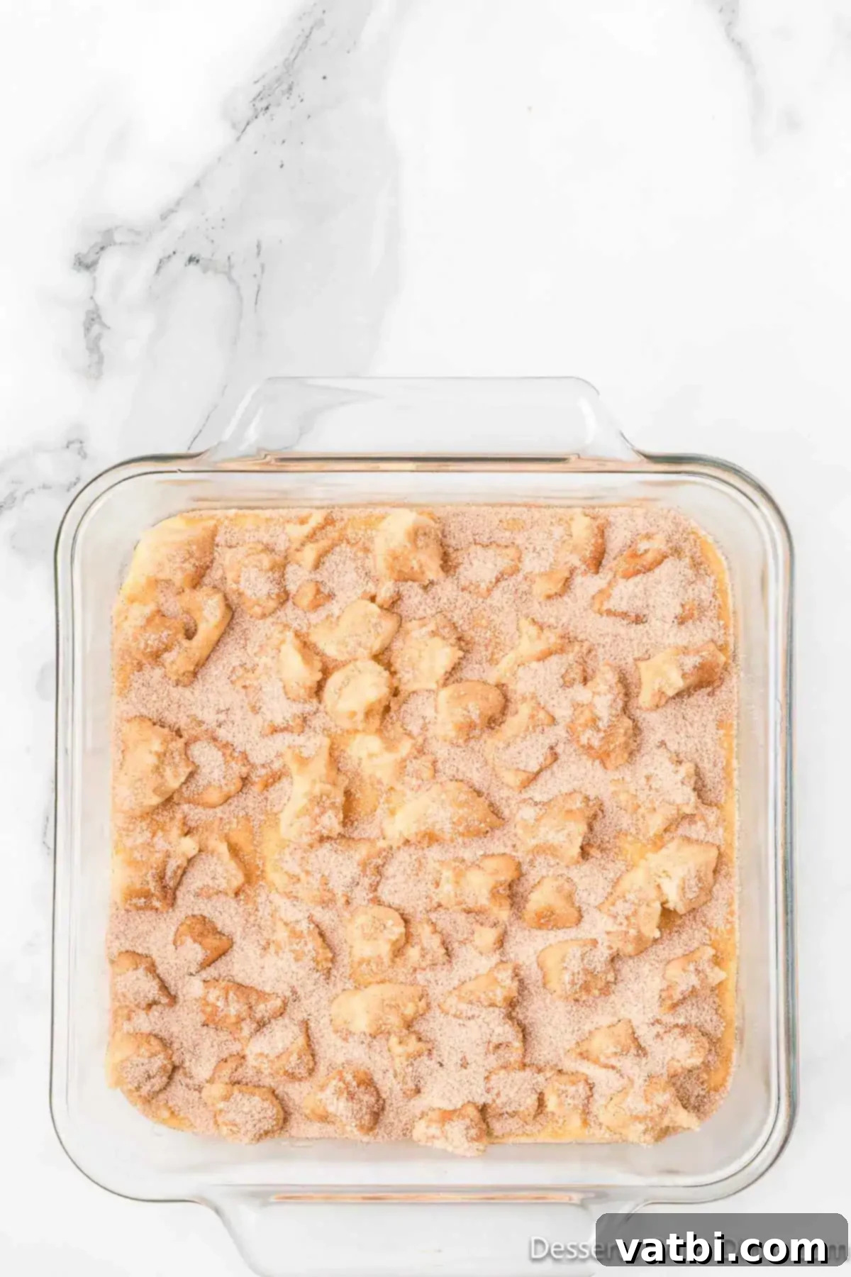 Dreamy Snickerdoodle Cheesecake Bars 11 Cinnamon sugar mixture sprinkled on top. The remaining cinnamon-sugar mixture is sprinkled evenly over the cookie dough crumbles and exposed cheesecake.