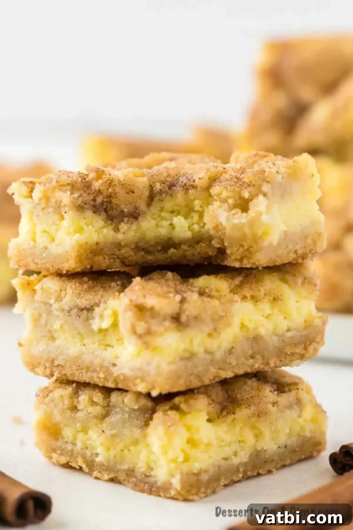 Dreamy Snickerdoodle Cheesecake Bars 13 Snickerdoodle Cheesecake Bars cut and ready to serve. Fully baked and chilled snickerdoodle cheesecake bars are cut into perfect squares and arranged for serving, showcasing all three delicious layers.