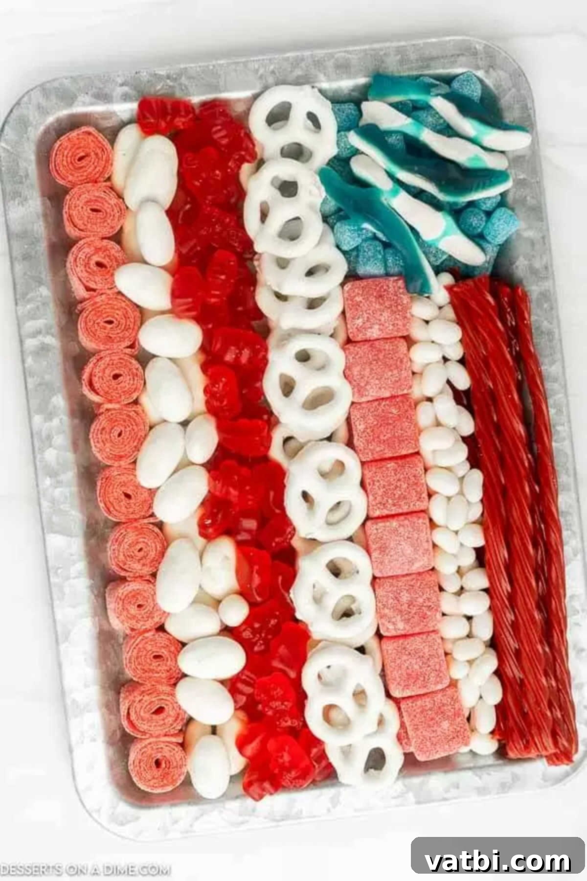 Star Spangled Sweet Treat Board 4 A completed American flag candy charcuterie board with red and white candy stripes and a blue section with white gummy sharks as stars.