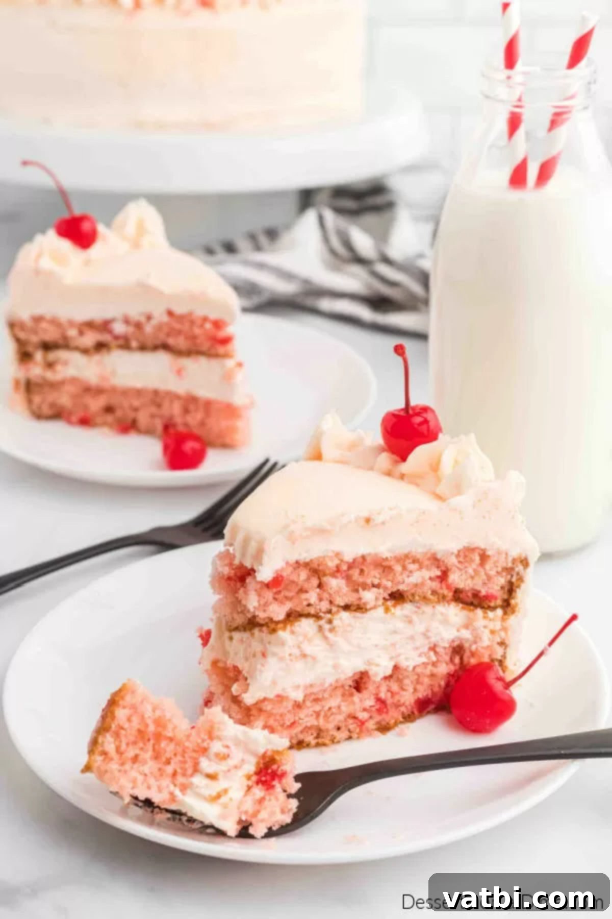Perfect Cherry Chip Cake 15 A slice of cherry chip cake on a plate, showing the moist pink cake and creamy frosting.